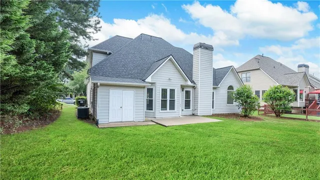 a view of a house with a yard and sitting area