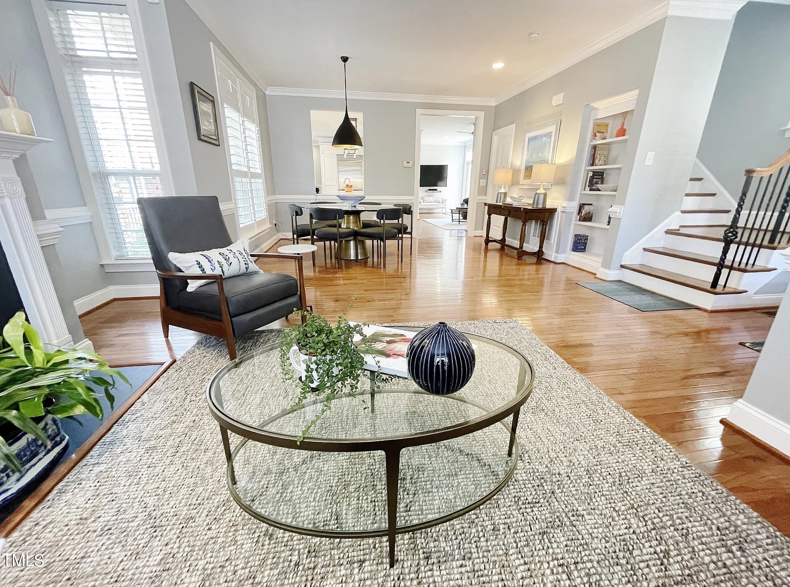1158 Haynes Street Raleigh, NC 27604 - Photo 3 of 36 a living room with furniture a dining table and a potted plant