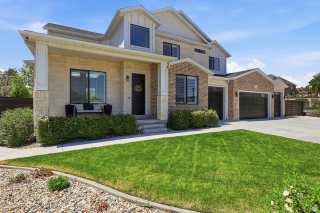 10676 Urban Rdg Cove South Jordan, UT 84095 - Photo 2 of 48 Modern two-story residence featuring a combination of light-colored stone and brick veneer exterior
