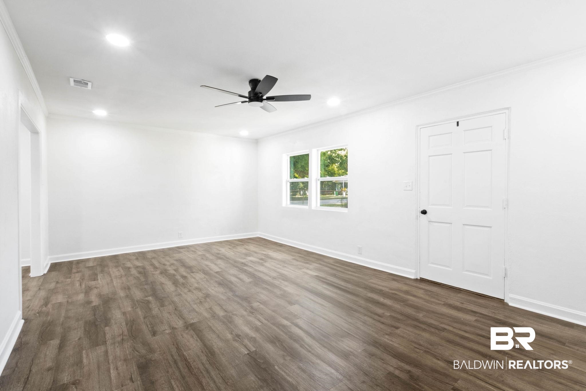 618 Pine Street Saraland, AL 36571 - Photo 10 of 41 Spare room with dark wood finished floors, ornamental molding, recessed lighting, and a ceiling fan