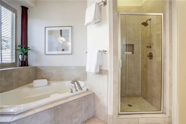 a bathroom with a bathtub and a shower