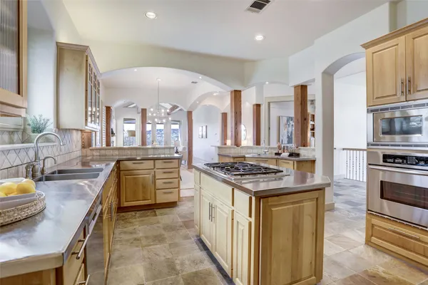 a kitchen with stainless steel appliances granite countertop a stove and a sink