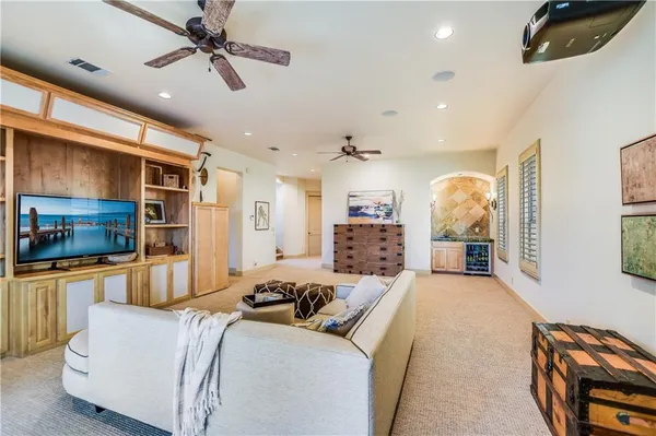 a large bedroom with a large bed a flat screen tv and a couch
