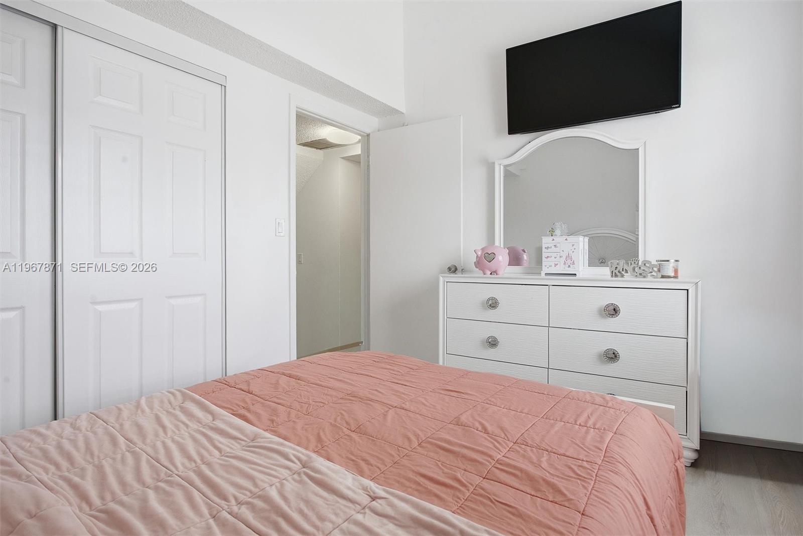 11781 Southwest 18th Street, Unit 640 Miami, FL 33175 - Photo 14 of 32 a bedroom with a bed and a flat screen tv