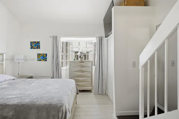 a bedroom with a bed and a mirror