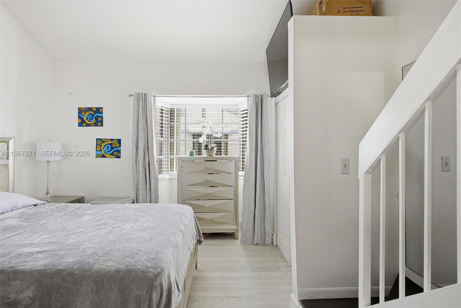 11781 Southwest 18th Street, Unit 640 Miami, FL 33175 - Photo 15 of 32 a bedroom with a bed and a mirror