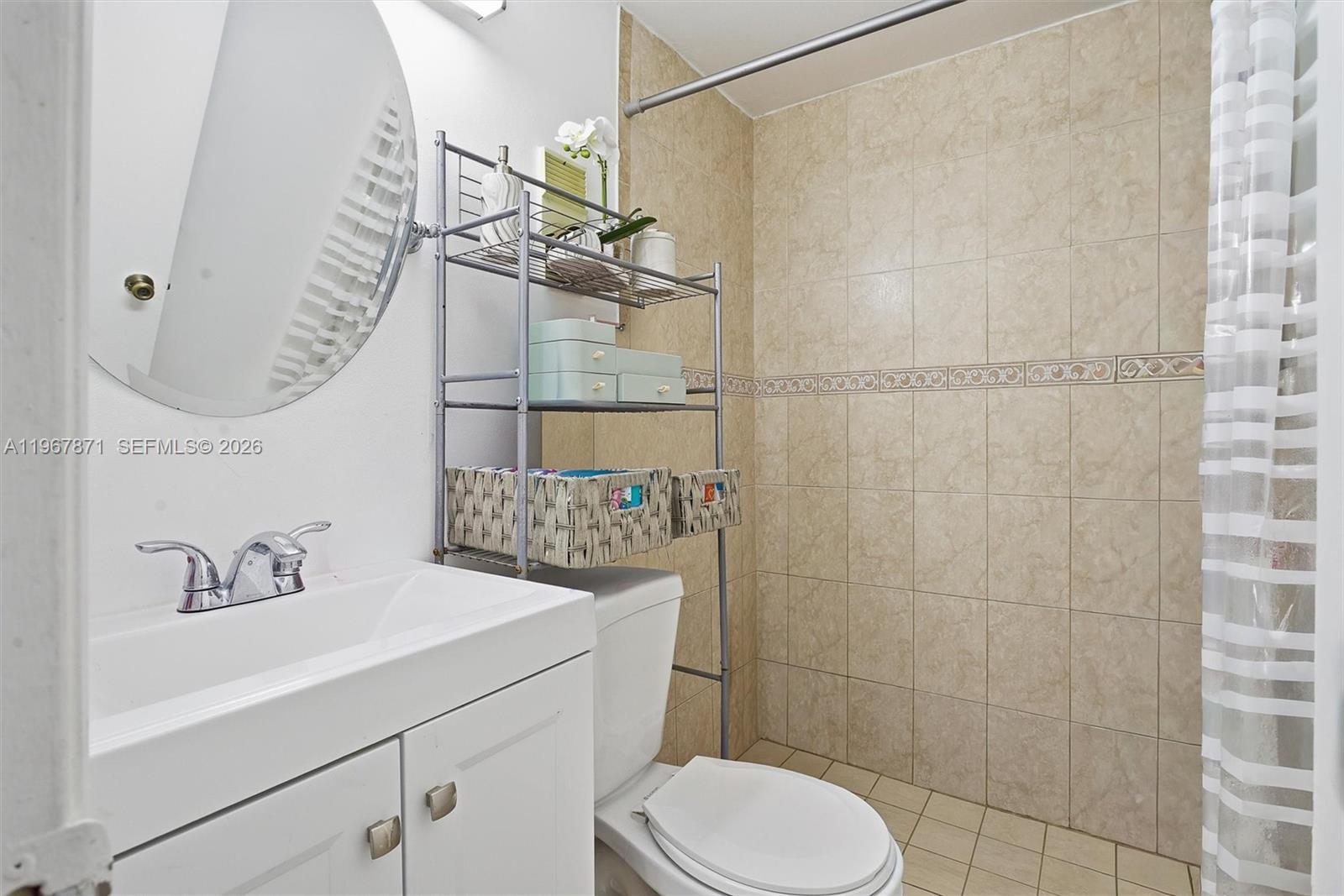 11781 Southwest 18th Street, Unit 640 Miami, FL 33175 - Photo 20 of 32 a bathroom with a sink a toilet and shower
