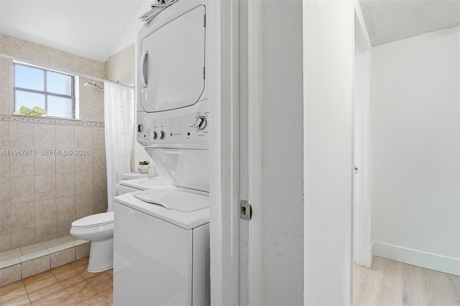 11781 Southwest 18th Street, Unit 640 Miami, FL 33175 - Photo 21 of 32 a bathroom with a granite countertop sink a toilet and shower