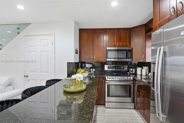 a kitchen with a stove microwave and refrigerator