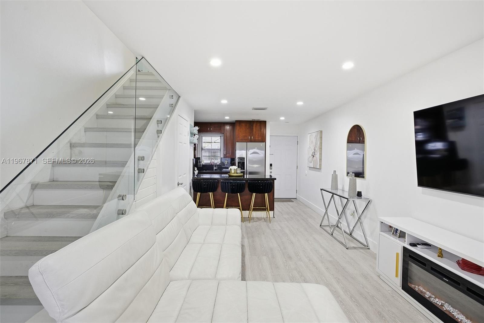 11781 Southwest 18th Street, Unit 640 Miami, FL 33175 - Photo 7 of 32 a living room with furniture and a flat screen tv