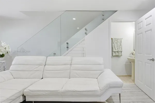 a living room with furniture and a ceiling fan