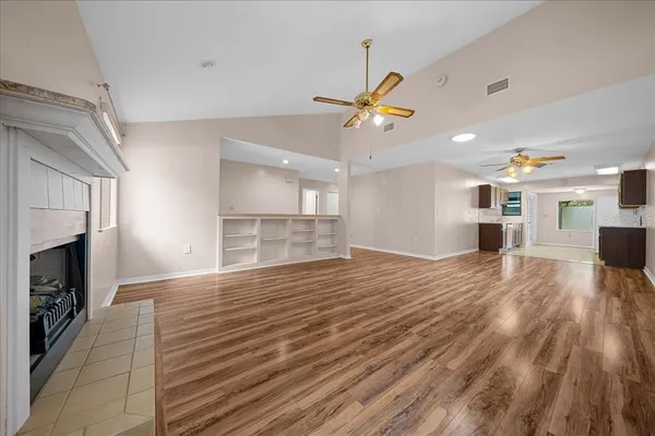 a large kitchen with stainless steel appliances granite countertop a sink stove and microwave