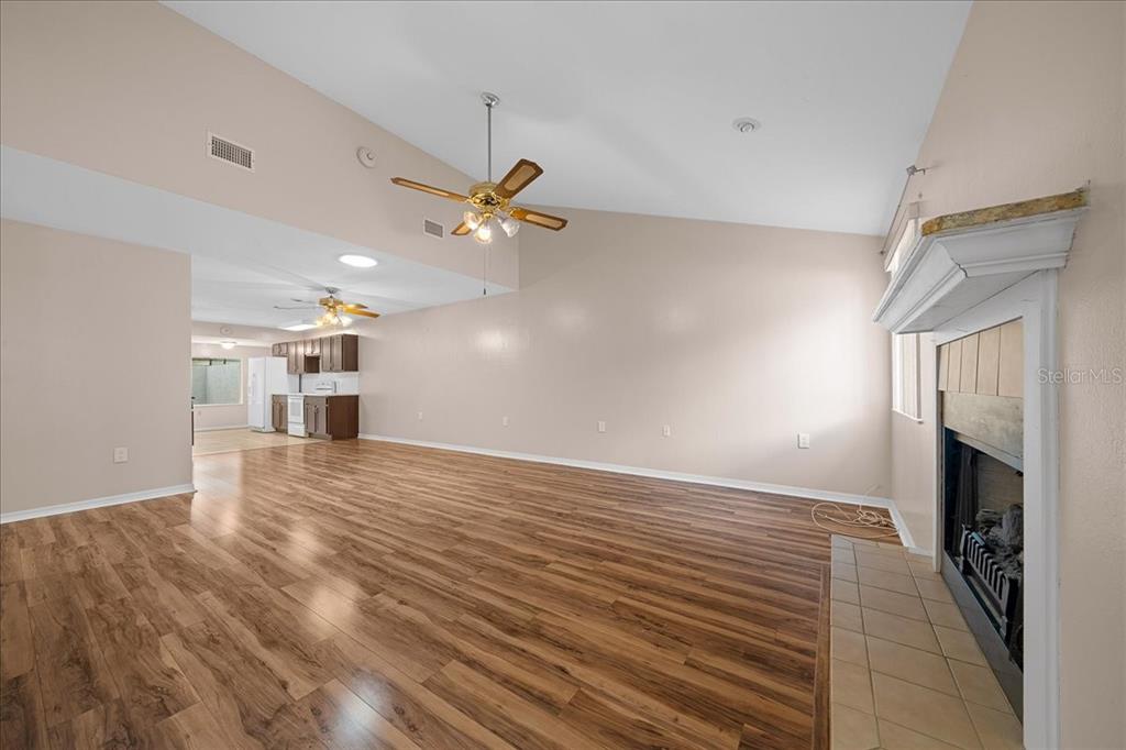 3702 Northeast 17th Street Ocala, FL 34470 - Photo 12 of 70 wooden floor in an empty room with a fireplace
