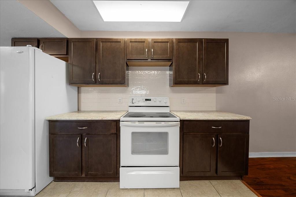 3702 Northeast 17th Street Ocala, FL 34470 - Photo 14 of 63 a stove top oven sitting inside of a kitchen