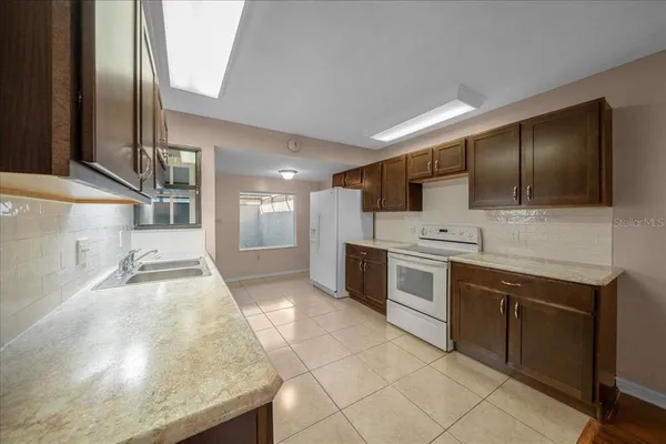 a kitchen with a sink and a refrigerator