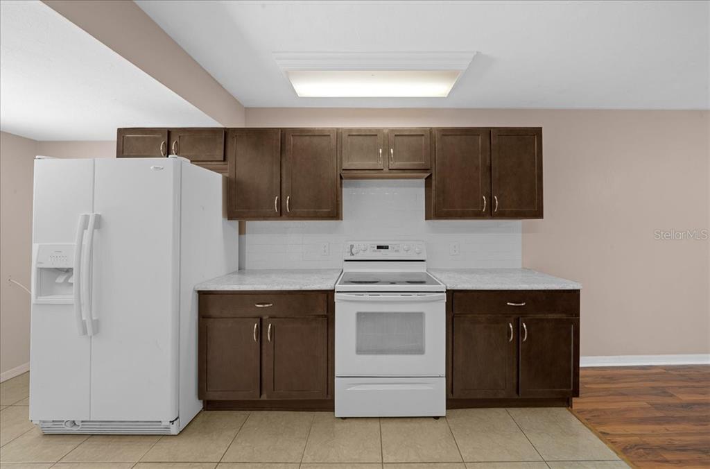 3702 Northeast 17th Street Ocala, FL 34470 - Photo 19 of 70 a kitchen with a sink and a refrigerator