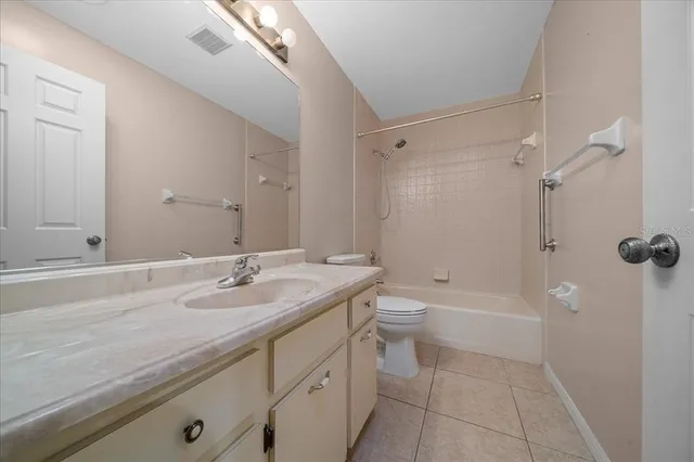 a spacious bathroom with a double vanity sink and a mirror