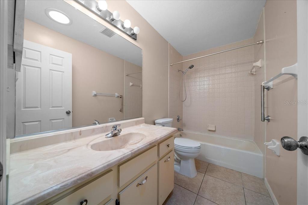 3702 Northeast 17th Street Ocala, FL 34470 - Photo 23 of 63 a bathroom with a sink a toilet and shower