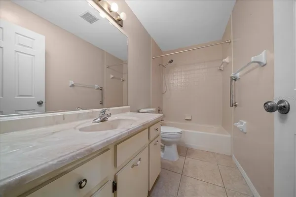 a spacious bathroom with a double vanity sink and a mirror