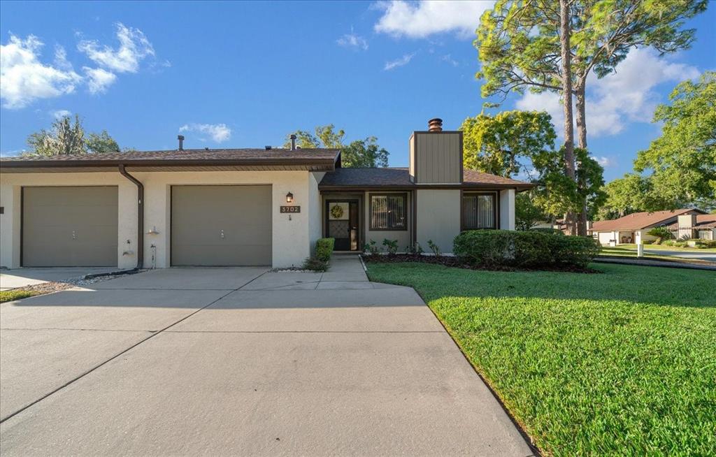 3702 Northeast 17th Street Ocala, FL 34470 - Photo 37 of 63 a front view of a house with a yard and garage