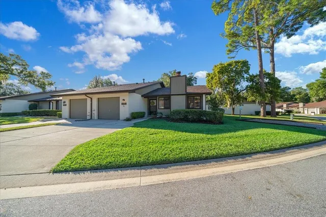 an aerial view of a house with garden space and street view