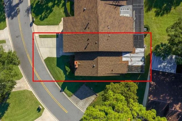 an aerial view of residential house with outdoor space and swimming pool