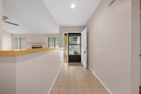 a view of a room with wooden floor and a bathroom