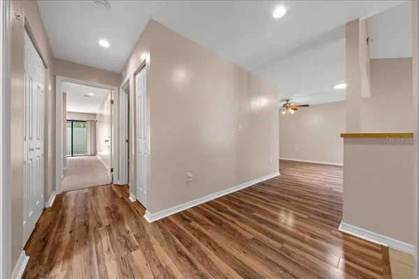 a view of empty room with wooden floor and fireplace