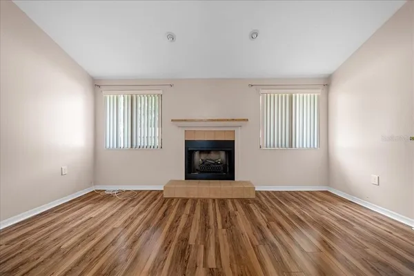 wooden floor in an empty room with a fireplace