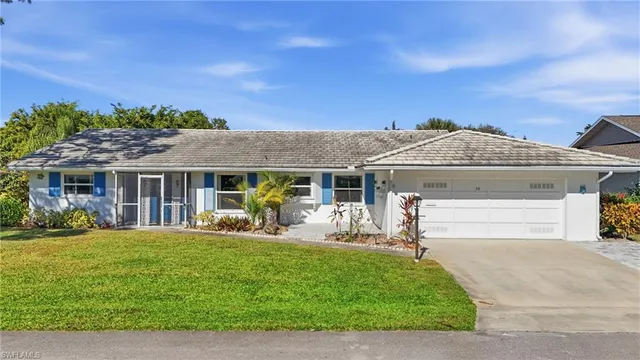 a front view of house with yard outdoor seating and green space