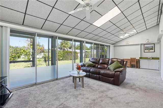 a living room with furniture and large windows