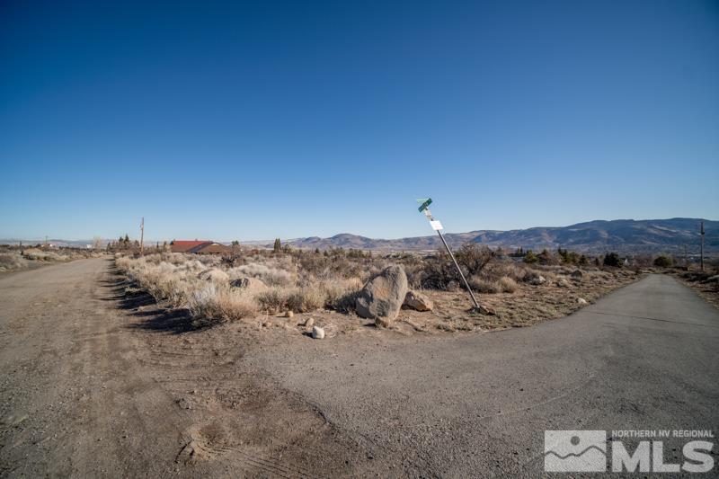 0 Spezia Road Reno, NV 89511 - Photo 15 of 17 a view of a dry yard with mountains in the background