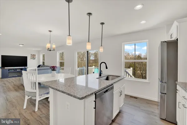 a kitchen with center island and a sink
