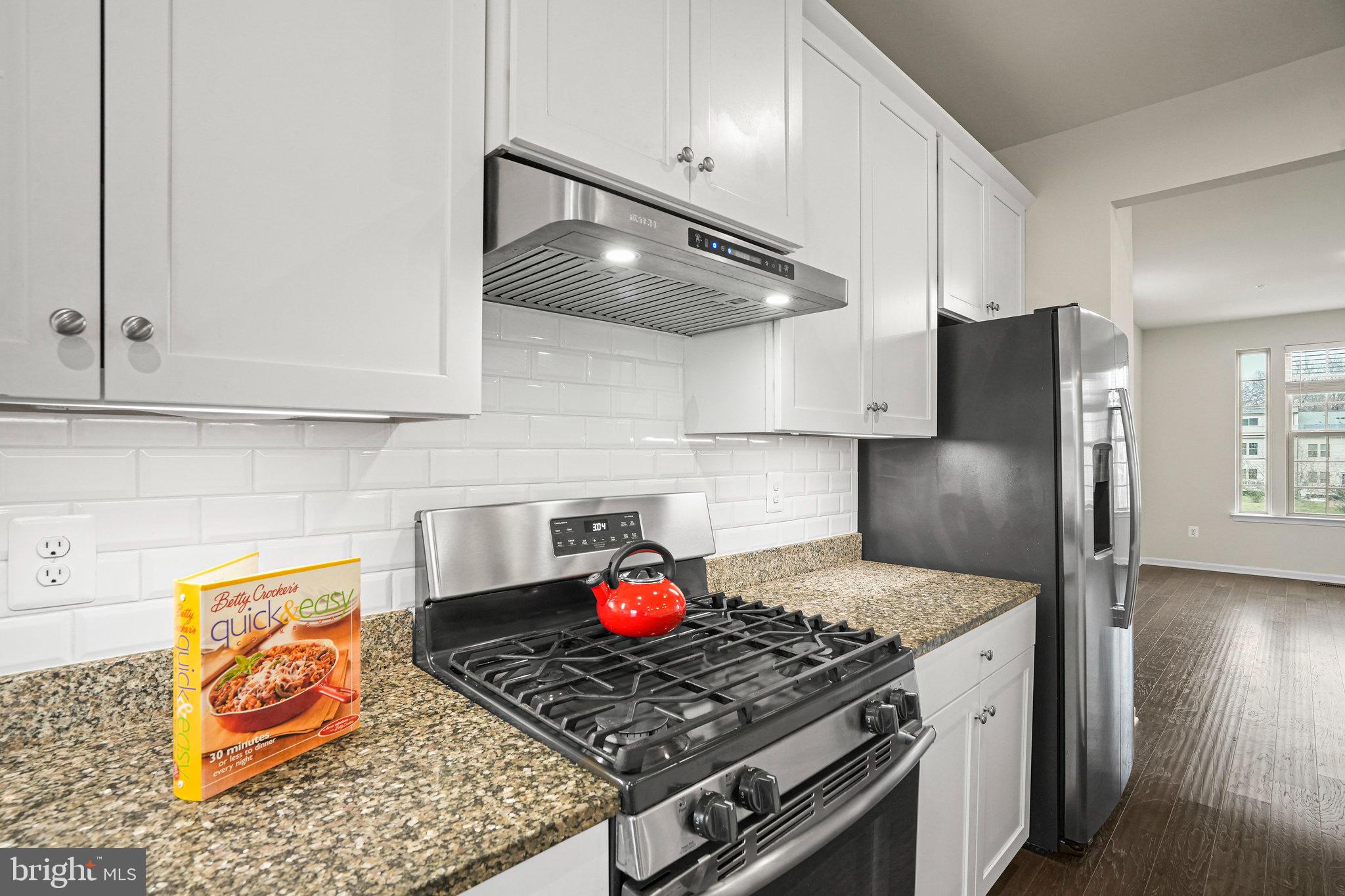2829 Fredericksburg Road Hanover, MD 21076 - Photo 11 of 37 a kitchen with stainless steel appliances granite countertop a stove a refrigerator and cabinets