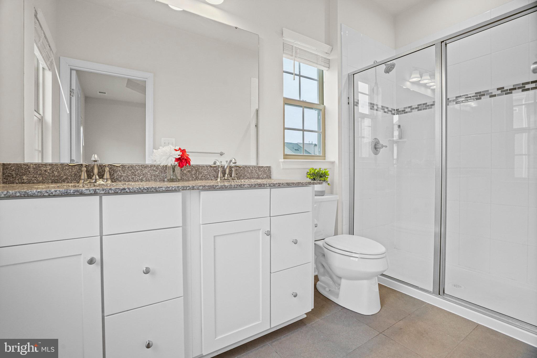 2829 Fredericksburg Road Hanover, MD 21076 - Photo 21 of 37 a bathroom with a sink toilet and shower