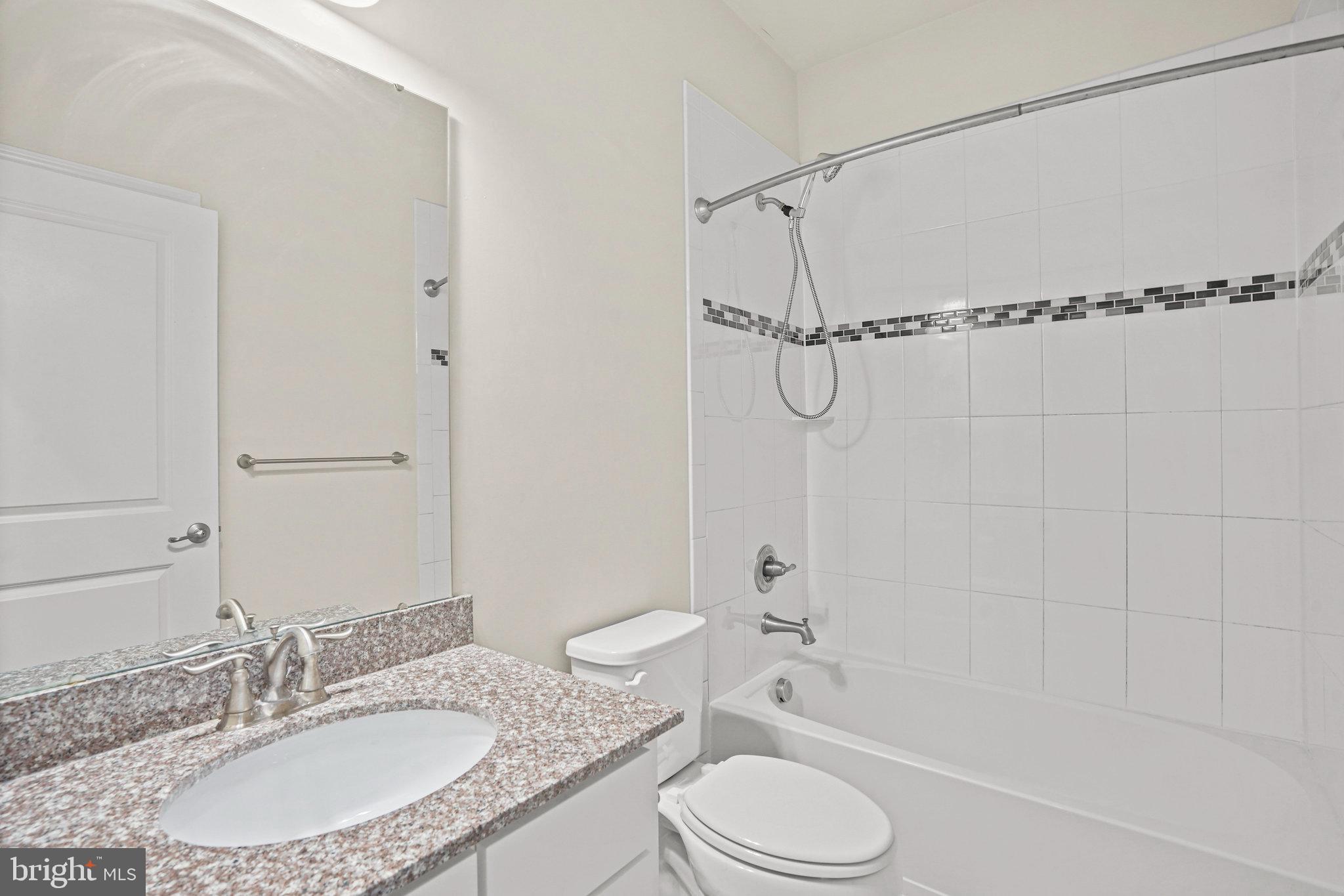 2829 Fredericksburg Road Hanover, MD 21076 - Photo 24 of 37 a bathroom with a granite countertop sink toilet and shower