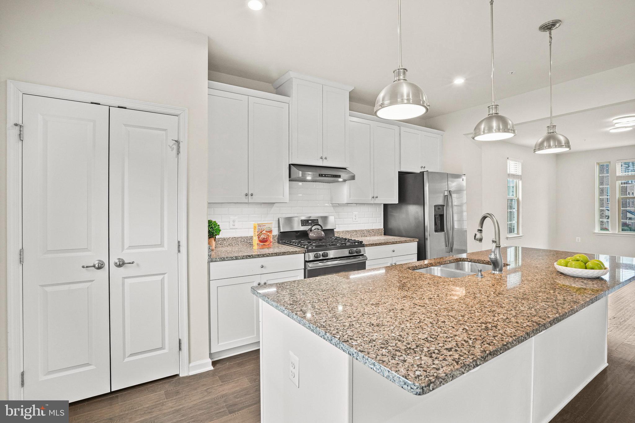 2829 Fredericksburg Road Hanover, MD 21076 - Photo 6 of 37 a kitchen with stainless steel appliances granite countertop a sink refrigerator and cabinets