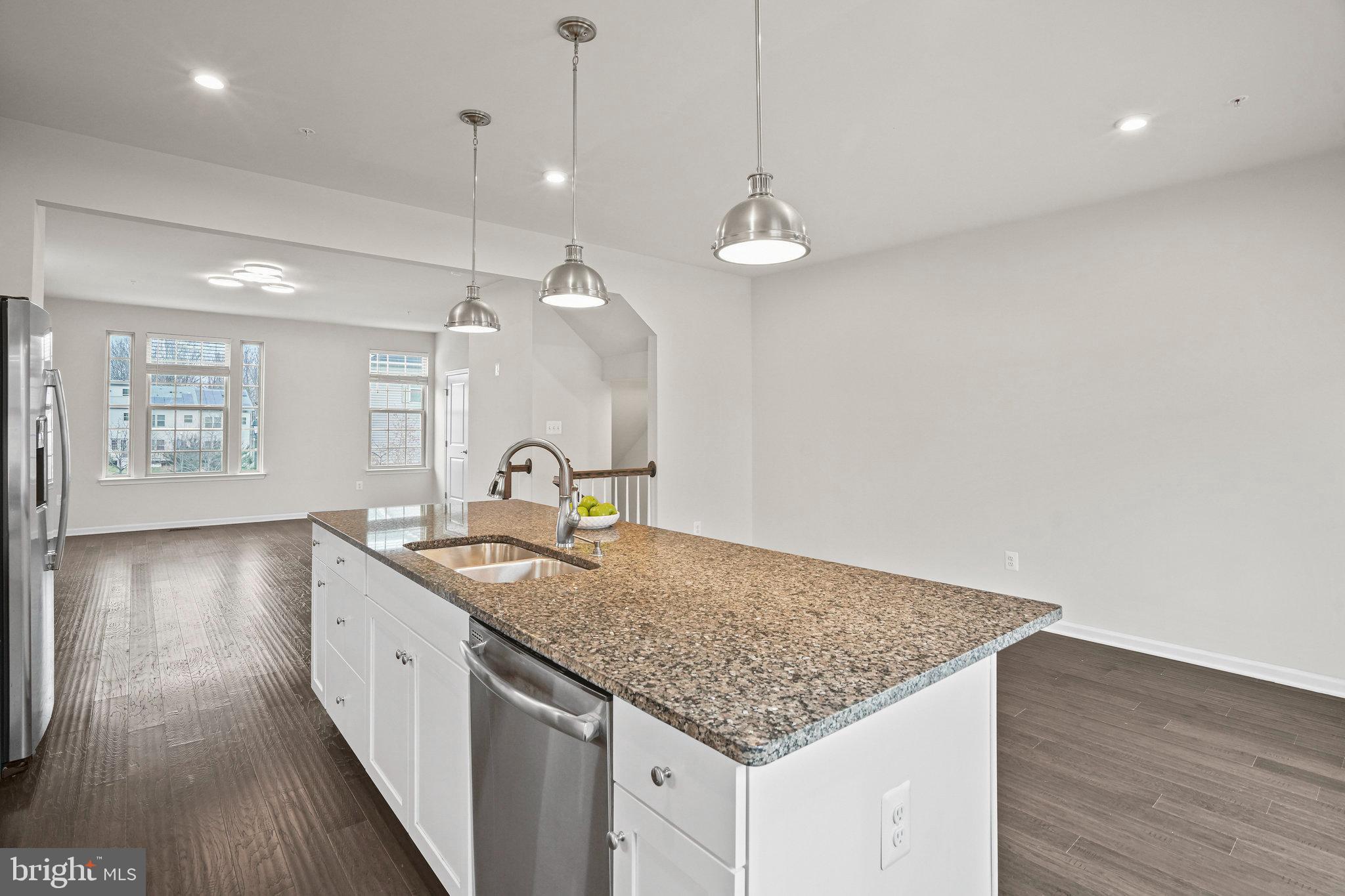 2829 Fredericksburg Road Hanover, MD 21076 - Photo 9 of 37 a kitchen with stainless steel appliances granite countertop a sink a oven and wooden floors
