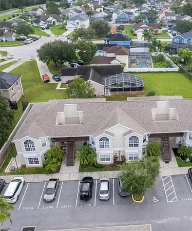 an aerial view of a house with a garden and lake view