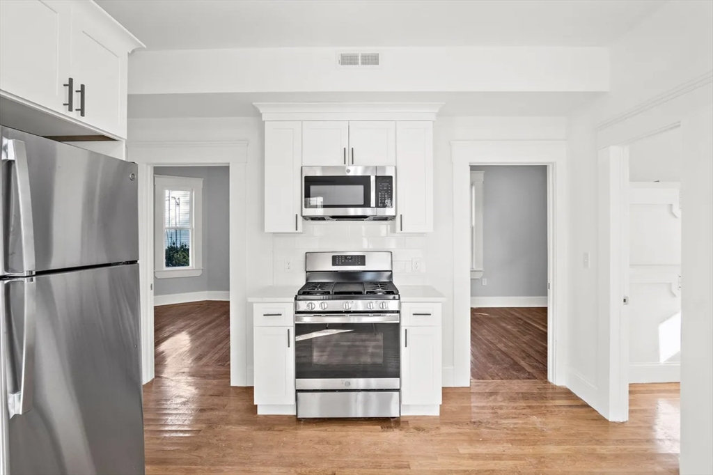 10 Sutton Street Boston, MA 02126 - Photo 5 of 26 a kitchen with a stove and a refrigerator
