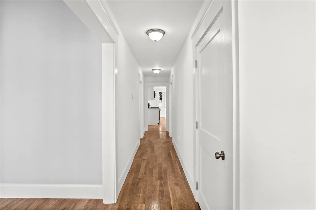 10 Sutton Street Boston, MA 02126 - Photo 9 of 26 a view of a hallway with wooden floor and staircase