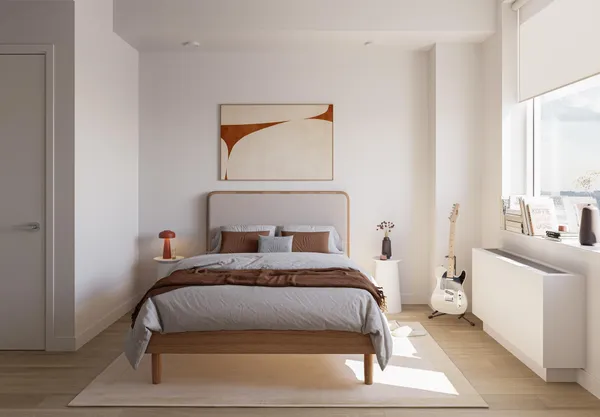 a bedroom with a bed and a window