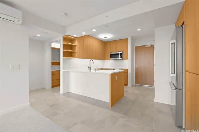 a view of kitchen with cabinets and refrigerator