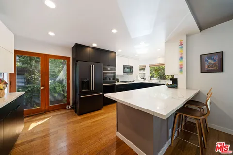 a kitchen with a sink a window and appliances
