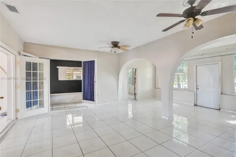 a view of empty room with windows and fan