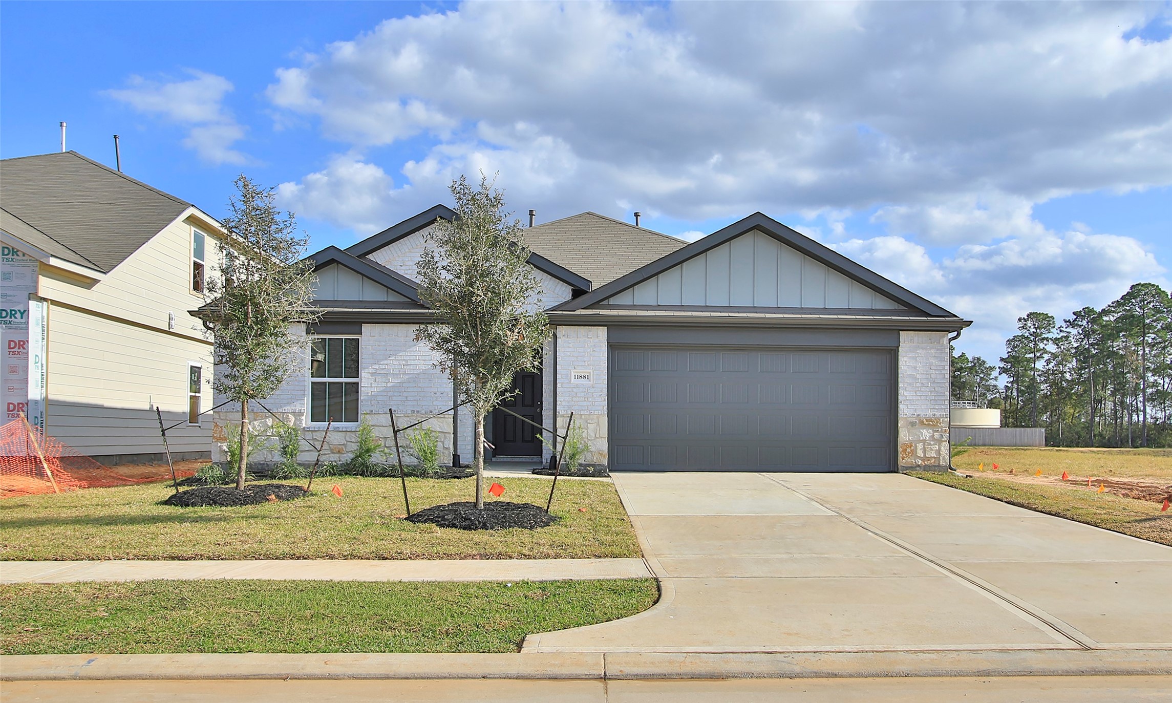 a front view of a house with a garden