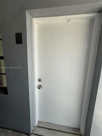 a large white kitchen with granite countertop a sink