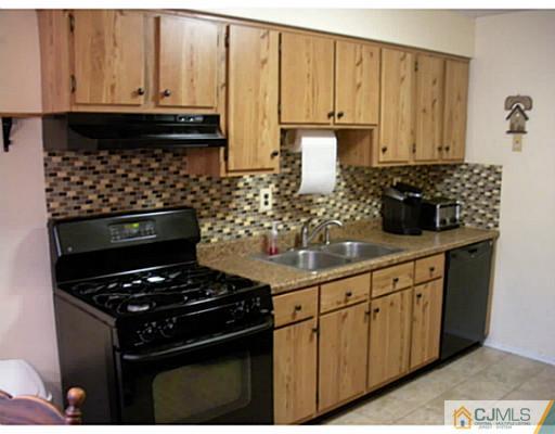 1618 Raspberry Court Edison, NJ 08817 - Photo 3 of 10 a kitchen with granite countertop a stove and cabinets