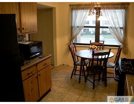 1618 Raspberry Court Edison, NJ 08817 - Photo 4 of 10 a dining room with furniture and a floor to ceiling window