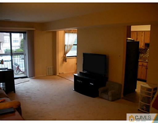 1618 Raspberry Court Edison, NJ 08817 - Photo 7 of 10 a living room with furniture and a flat screen tv